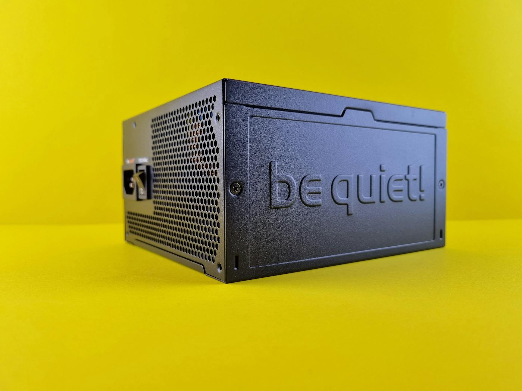 Image of a Power supply unit with a yellow coloured background.