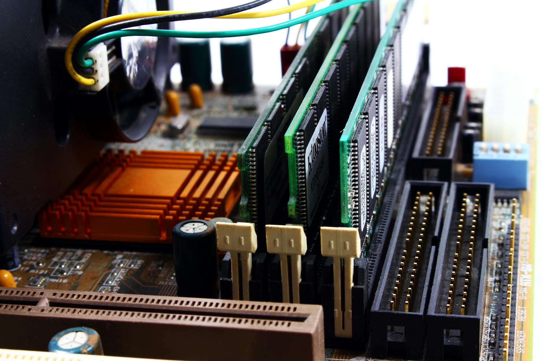 Image of 3 RAM sticks placed on a mother board.