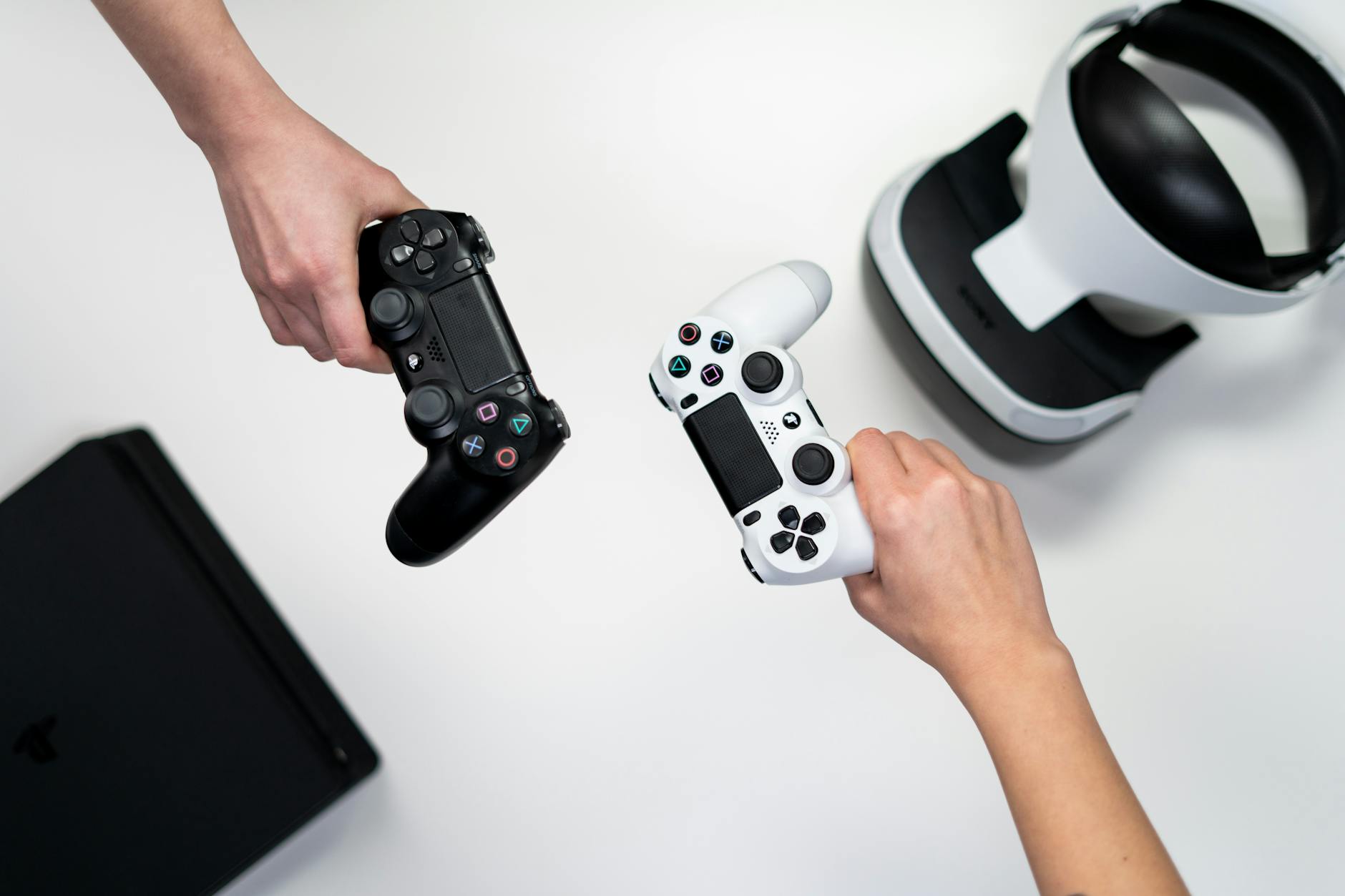 An image of a black and white coloured joysticks and a playstation.