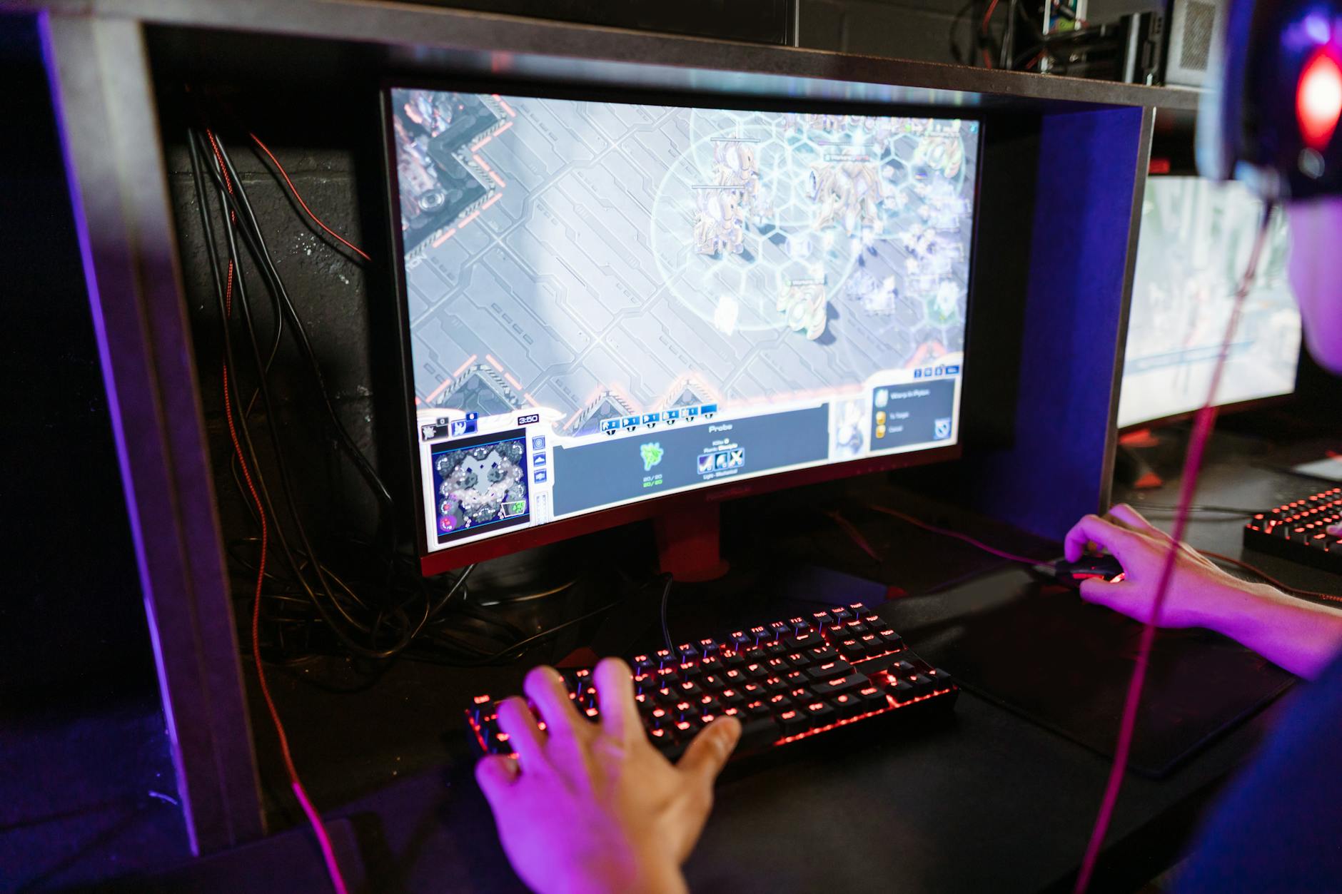 Image of a gamer gaming on computer with his headset.